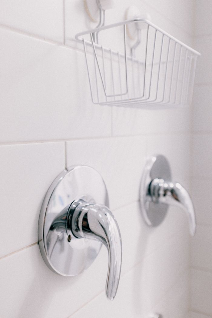 Close-up of chrome bathroom fixtures with a clean, minimalist design.