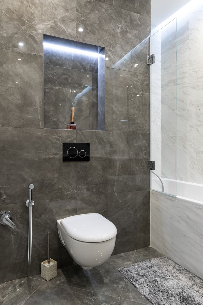 Elegant modern bathroom with marble walls and fixtures.